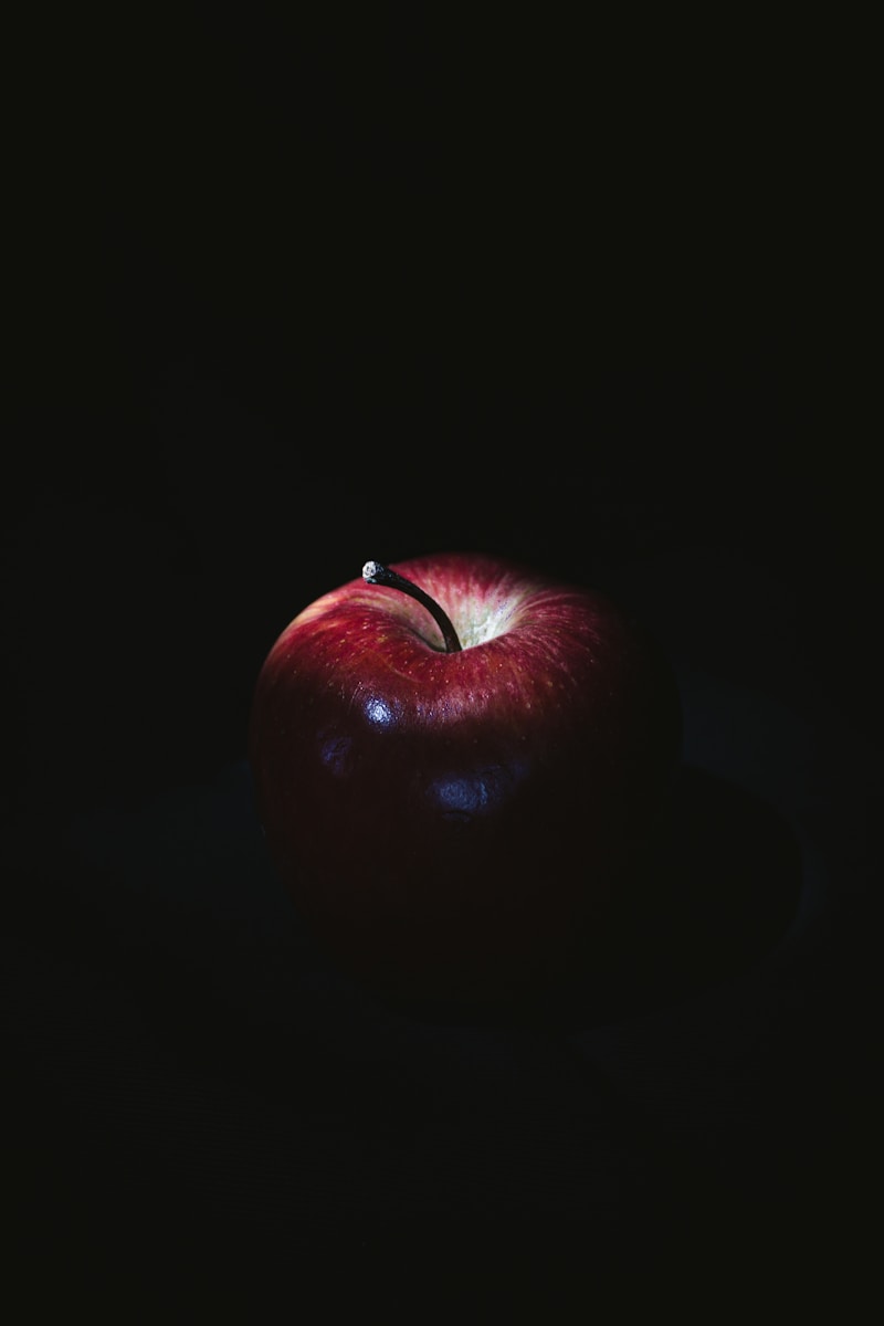 red apple on black surface