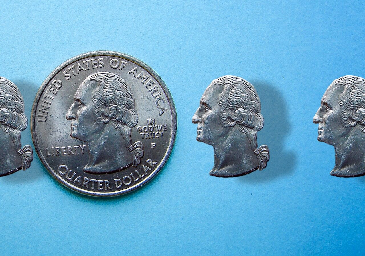 A penny with five heads of people on it