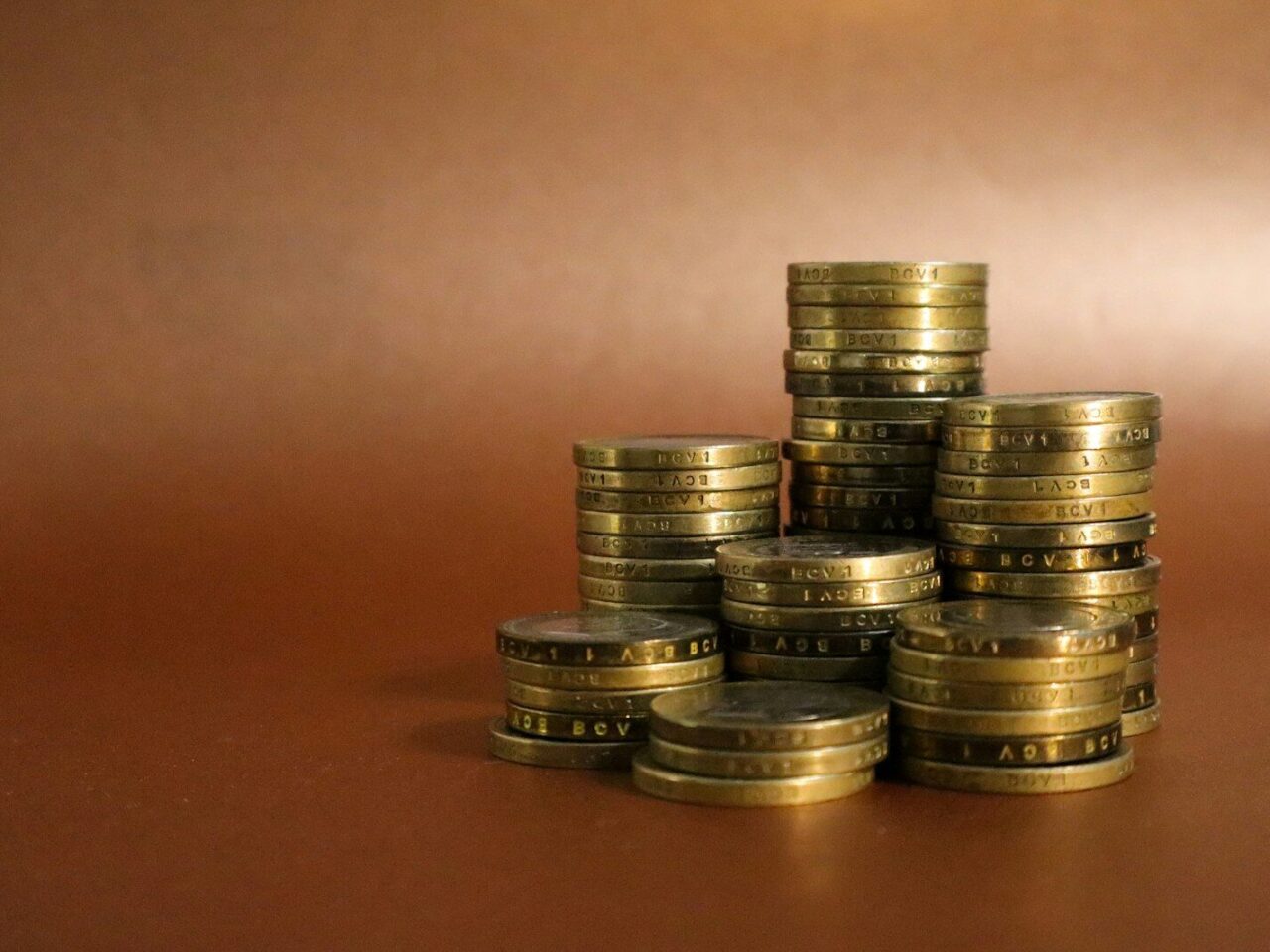 A pile of gold coins sitting on top of a table